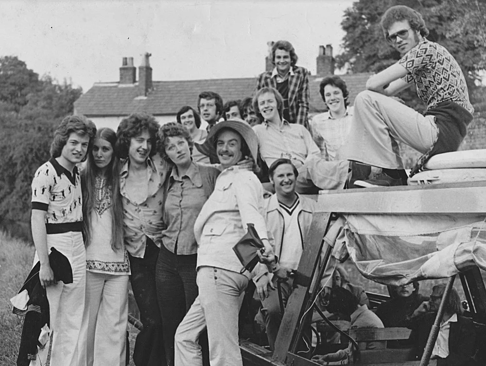 The Story of LGBTQ+ Activism in Lancaster and Morecambe Relaxed group photo of men and women including Paul O'Grady third from left.