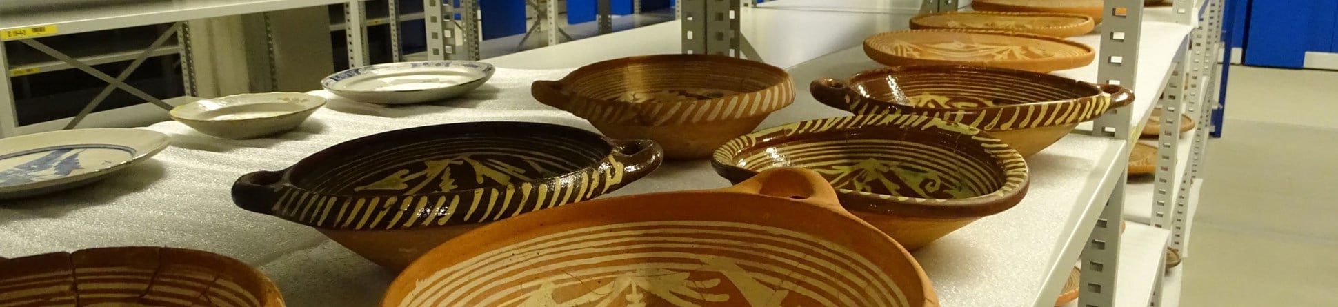 Ceramic vessels on a shelf in an archaeological store.