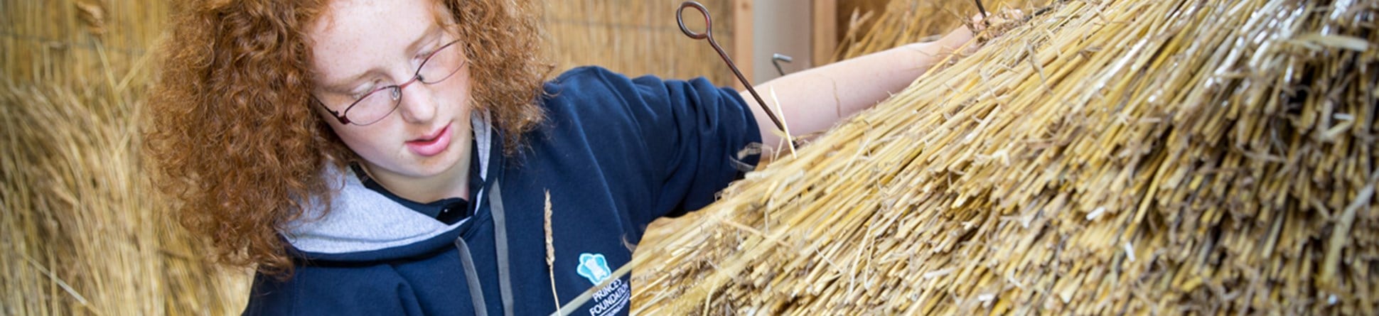 Find new routes into careers in the heritage sector with traditional skills programmes An image of King's Foundation trainee Miriam Johnson, learning traditional methods of thatching, as part of her bursary placement on the Building Craft Programme