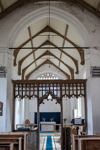 Internal photo of a church, showing the aisle.